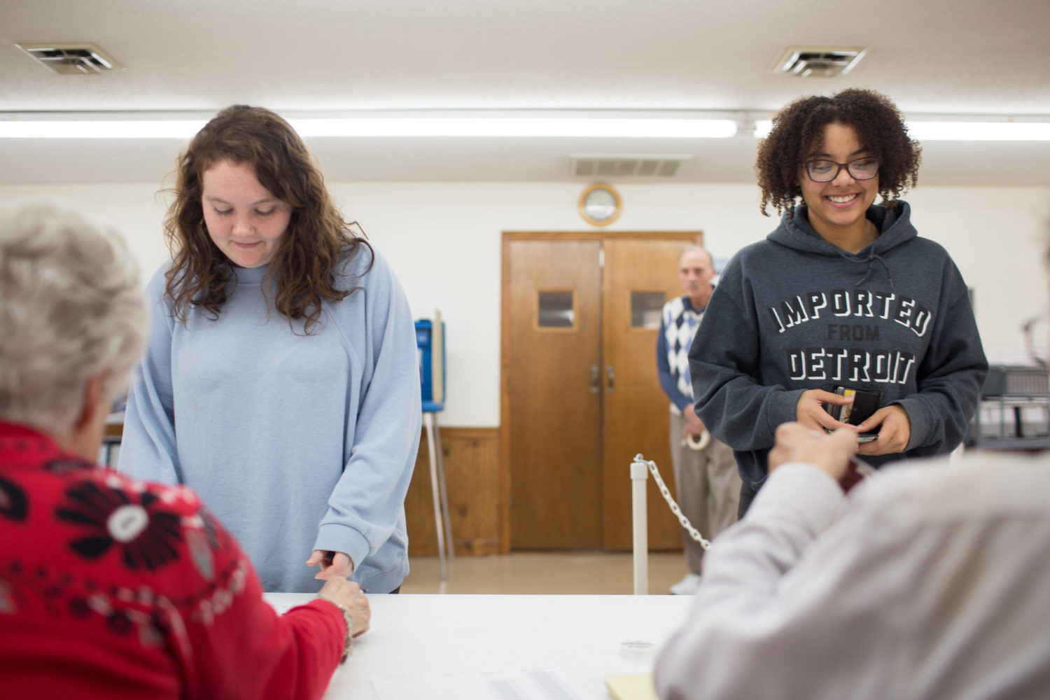 Lanie Hamrick, left, and Destinee Terry, both students at Asheville-Buncombe Technical Community College, check in to pick up their primary election ballots at the Old Fort Wesleyan Church polling place in McDowell County on March 3, 2020. Colby Rabon / Carolina Public Press